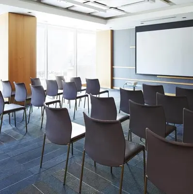 a class room with chairs and a white screen at Le Germain Hotel Maple Leaf Square in Toronto