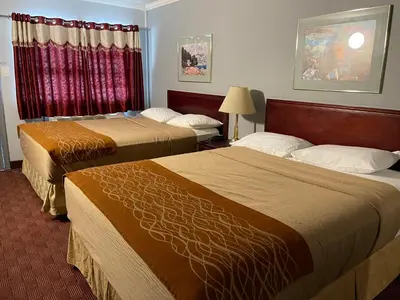 a hotel room with two beds and a window at Liberty Inn in Bowmanville