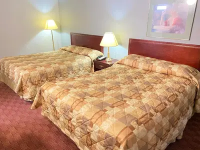 a hotel room with two beds and two lamps at Liberty Inn in Bowmanville