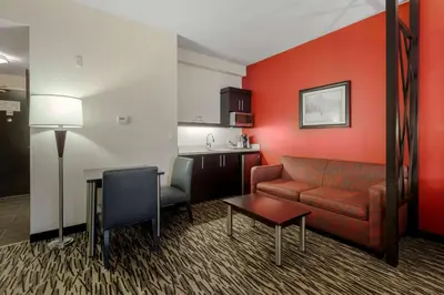 a living room with a couch and a table at C Hotel by Carmen's, BW Premier Collection in Hamilton