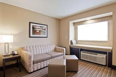 a living room with a couch and a window at Best Western Plus Woodstock Inn & Suites in Woodstock