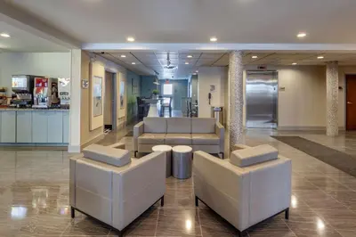 a lobby with two chairs and a waiting room at Best Western Plus Woodstock Inn & Suites in Woodstock