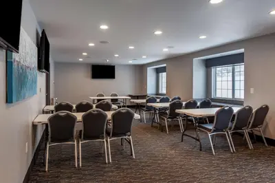 a conference room with tables and chairs and a tv at Best Western Plus Woodstock Inn & Suites in Woodstock
