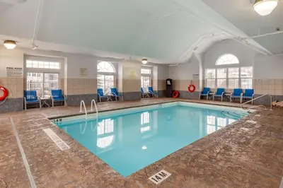 a pool with blue water in a building at Best Western Plus Woodstock Inn & Suites in Woodstock