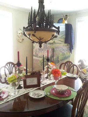 a dining room table with a chandelier above it at Four Ninety Muskoka B & B in Gravenhurst