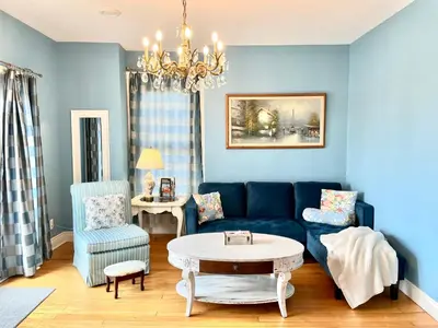 a living room with a blue couch and a table at Redwood Bed and Breakfast in Niagara Falls