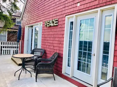 a table and chairs sitting outside of a red house at Redwood Bed and Breakfast in Niagara Falls