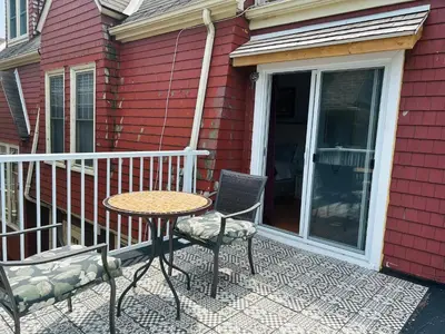 a patio with a table and chairs on a porch at Redwood Bed and Breakfast in Niagara Falls
