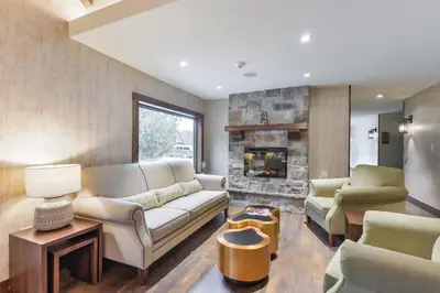 a living room with a couch and a fireplace at Northumberland Heights Wellness Retreat & Spa in Cobourg