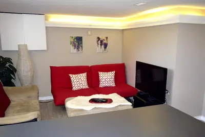 a living room with a red couch and a tv at Bradford Vacation in Bradford
