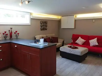 a living room with a red couch and a red sofa at Bradford Vacation in Bradford
