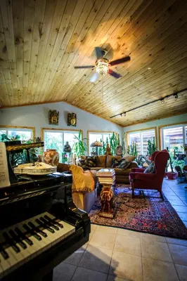 a living room with a piano and a couch at Shambhala Bed and Breakfast in Buckhorn