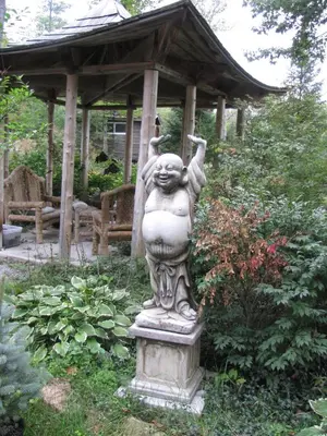 a statue in a garden with a gazebo at Shambhala Bed and Breakfast in Buckhorn