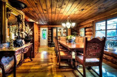 a dining room with a wooden table and chairs at Shambhala Bed and Breakfast in Buckhorn