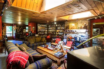 a living room with couches and a table at Shambhala Bed and Breakfast in Buckhorn