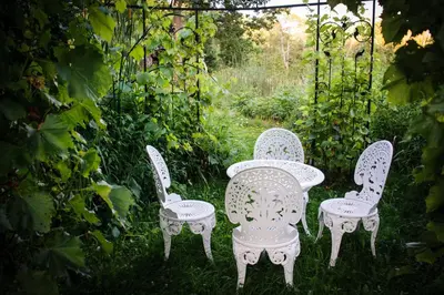 two chairs and a table in a garden at Shambhala Bed and Breakfast in Buckhorn