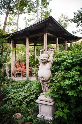 a statue in a garden with a gazebo at Shambhala Bed and Breakfast in Buckhorn
