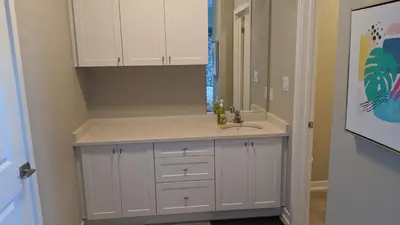a bathroom with a sink and a mirror at Boardwalk Homes - Vacation Homes & Executive Suites in Kitchener
