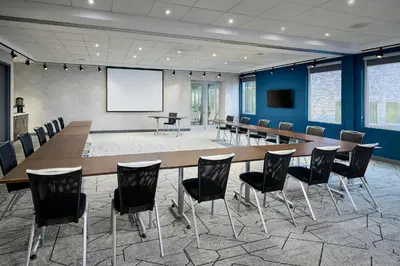 a conference room with a long table and chairs at Aloft Vaughan Mills in Vaughan
