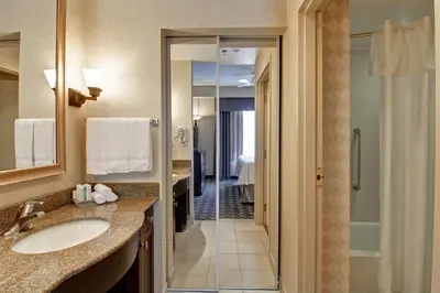 a bathroom with a sink and a walk in shower at Homewood Suites by Hilton Toronto Oakville in Oakville
