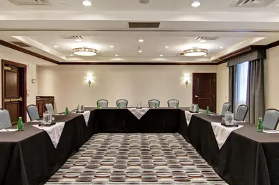 a conference room with tables and chairs in it at Homewood Suites by Hilton Toronto Oakville in Oakville