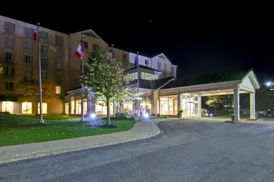 a building with lights in front of it at night at Hilton Garden Inn Toronto/Mississauga in Mississauga