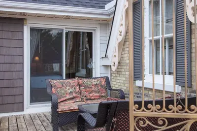 a couch sitting on a porch next to a window at Avery House B&B in Stratford