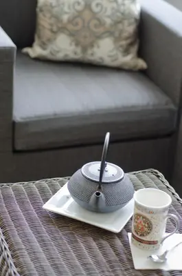 a table with a hat and a coffee cup on it at Avery House B&B in Stratford