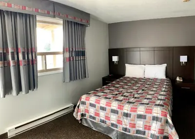 a hotel room with a bed and a window at Milestone Motel in Collingwood