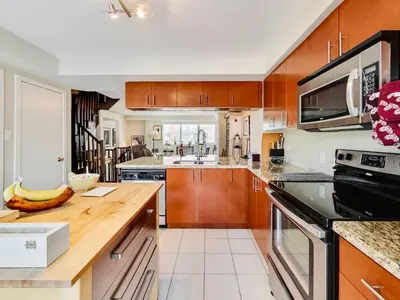 a kitchen with wooden cabinets and a counter top at Home in Downtown in Toronto