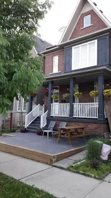 a house with a picnic table and a bench in front of it at Village at York U in Toronto