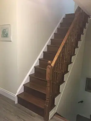 a wooden staircase in a room with a stair case at Village at York U in Toronto