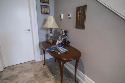 a table in a hallway with a lamp on it at Evanndor in Stratford