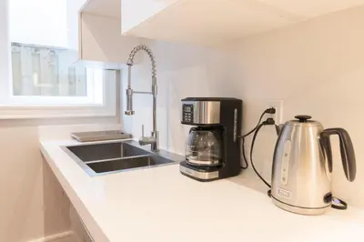 a kitchen counter with a coffee maker and a coffeemaker at Hillcrest Modern House in Toronto