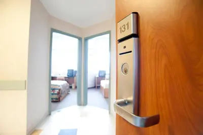 an open door to a room with a bedroom at Residence & Conference Centre- Barrie in Barrie