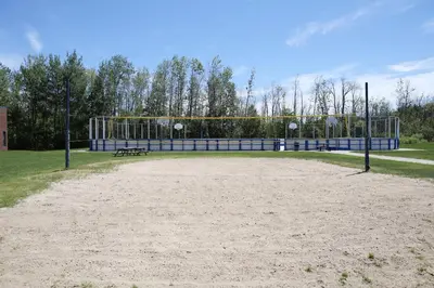 a volley ball court with a goal and a bench at Residence & Conference Centre- Barrie in Barrie