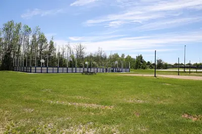 a park with a bench in the middle of a field at Residence & Conference Centre- Barrie in Barrie