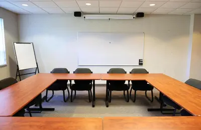 a conference room with a large table and chairs at Residence & Conference Centre- Barrie in Barrie