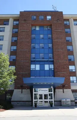 a large brick building with a door in front at Residence & Conference Centre- Barrie in Barrie