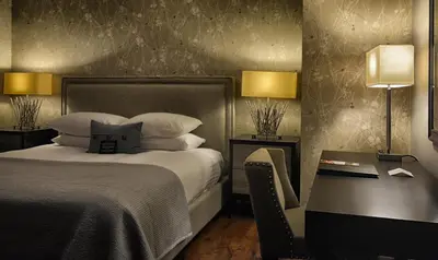 a hotel room with a bed and a desk with a bed sidx sidx at Hockley Valley Resort in Orangeville