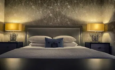 a bedroom with a bed with pillows and two lamps at Hockley Valley Resort in Orangeville