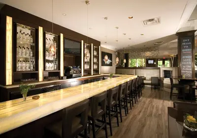 a bar with a row of chairs in a restaurant at Hockley Valley Resort in Orangeville