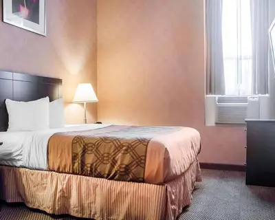 a hotel room with a bed and a window at Woodstock Inn and Suites in Woodstock