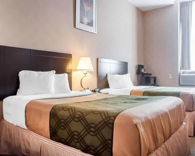 a hotel room with two beds in a room at Woodstock Inn and Suites in Woodstock