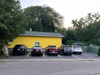 a group of cars parked in a parking lot at Cozy House B&B in Niagara Falls