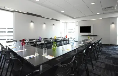 a conference room with a long table and chairs at Alt Hotel Toronto Airport in Mississauga