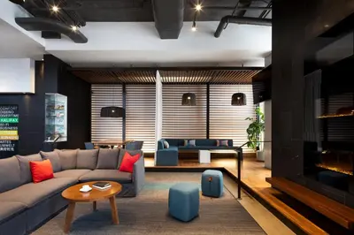 a living room with a couch and a fireplace at Alt Hotel Toronto Airport in Mississauga