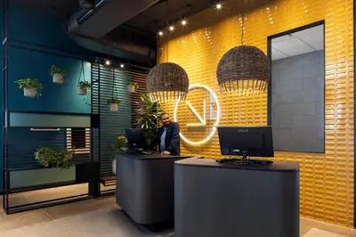 a man sitting at a desk in an office at Alt Hotel Toronto Airport in Mississauga
