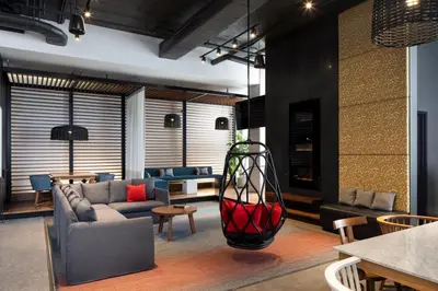 a living room with a couch and a vase at Alt Hotel Toronto Airport in Mississauga