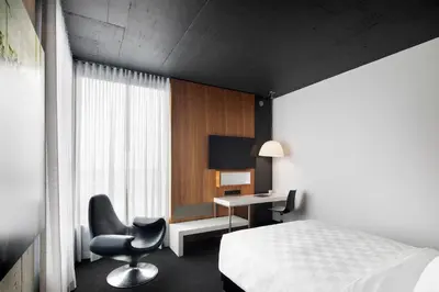 a bedroom with a bed and a desk and a chair at Alt Hotel Toronto Airport in Mississauga